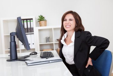 Businesswoman Having Backache At Work