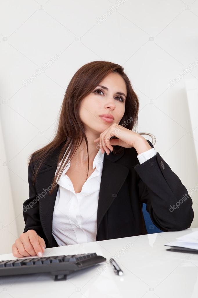 Businesswoman dreaming at workplace