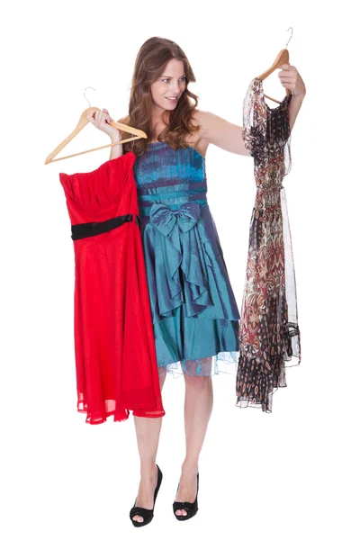 Fashion model with choice of dresses — Stock Photo, Image