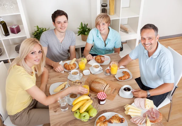 Happy family enjoying breakfast — Stock Photo, Image