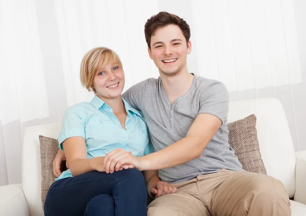 Loving couple relaxing on a sofa — Stock Photo, Image