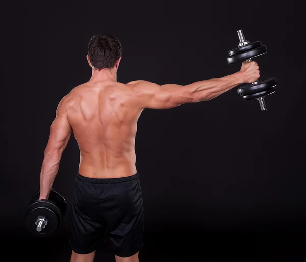 Hombre joven haciendo ejercicio con levantamiento de pesas —  Fotos de Stock