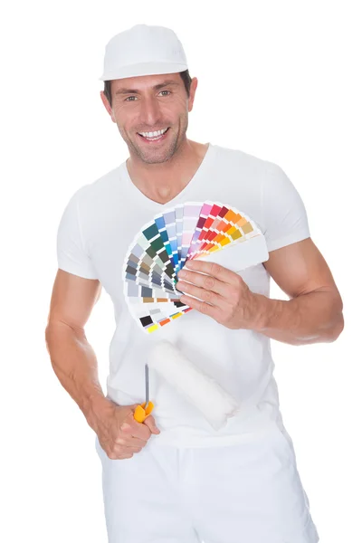 Pintor sosteniendo un rodillo de pintura y espectro — Foto de Stock