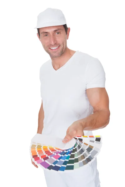 Pintor segurando um rolo de pintura e espectro — Fotografia de Stock
