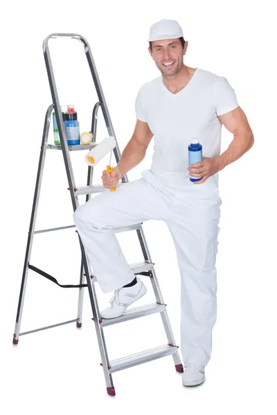 Painter Holding A Paint Roller And Paint Bottle — Stock Photo, Image