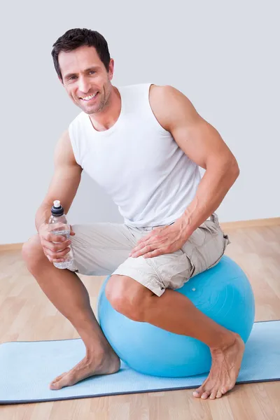 Joven sosteniendo una botella de agua — Foto de Stock