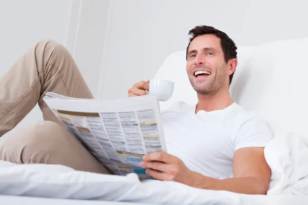 Young Man Holding Cup In Hand Reading Newspaper — Stock Photo, Image