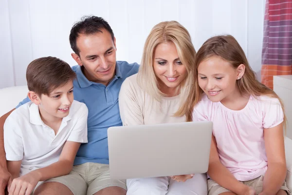 Met behulp van laptop en gelukkige familie — Stockfoto