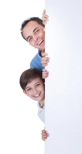 Retrato de pai e menino atrás do quadro em branco — Fotografia de Stock