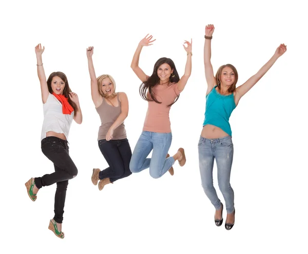 Vier jonge vrouw te springen van vreugde — Stockfoto