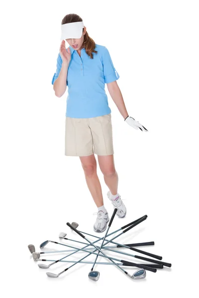 Golfer looking aghast at scattered clubs — Stock Photo, Image