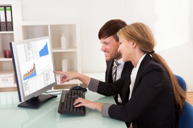 Business looking at sales charts clipart