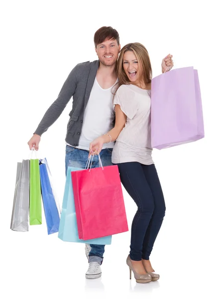 Chico y chica trae bolsas de compras — Foto de Stock