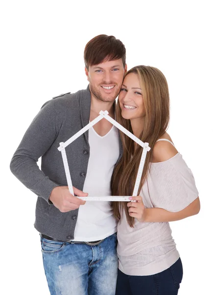 Smiling couple posing inside a frame — Stock Photo, Image