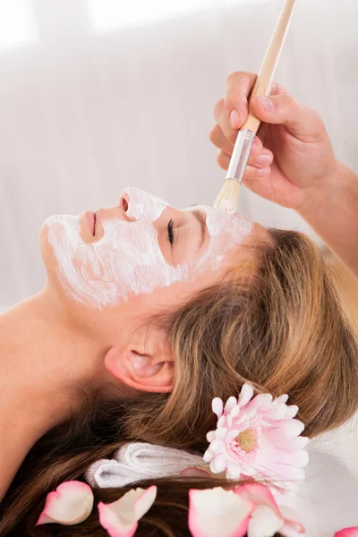 Esteticista aplicando una mascarilla facial — Foto de Stock