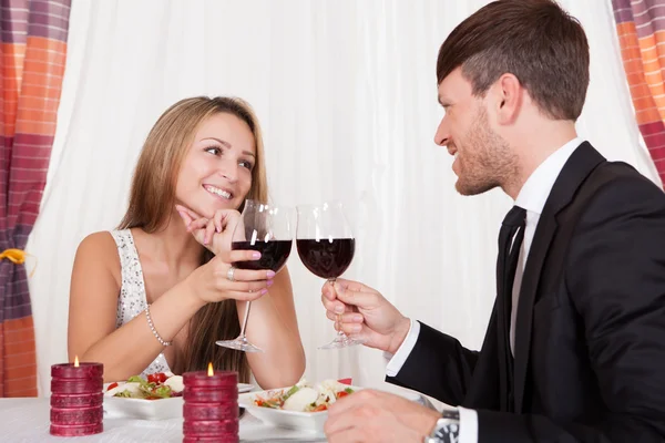 Romantic couple toasting each other — Stock Photo, Image