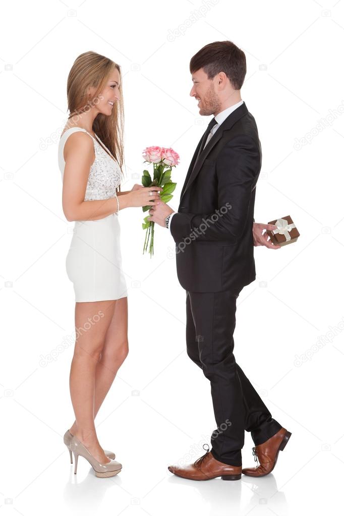 Man giving fresh flowers to woman