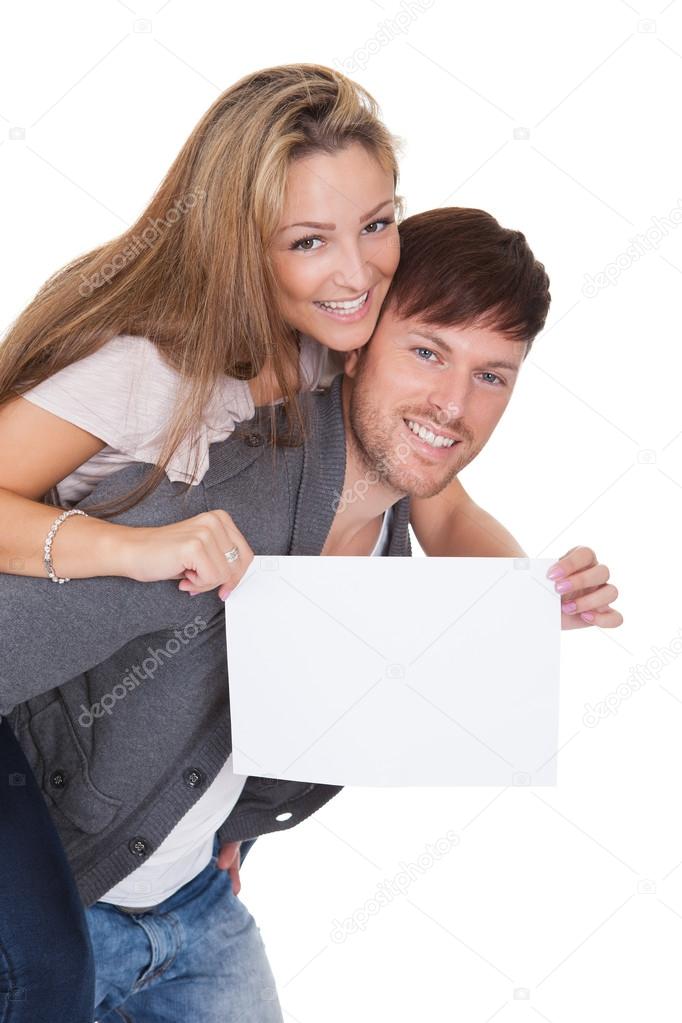 Woman getting a piggyback ride with blank sign