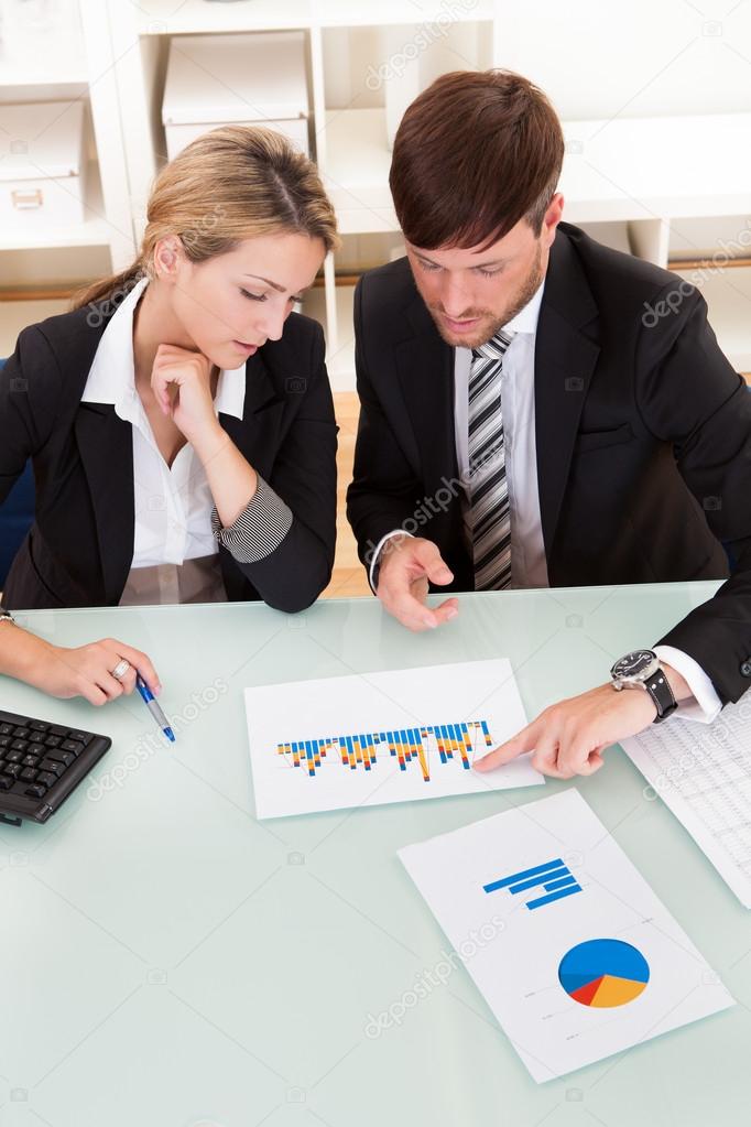 Business colleagues discussing a bar graph