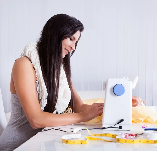 Mulher trabalhando com sua máquina de costura — Fotografia de Stock