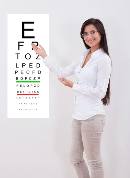 女性の視力検査表を指す — ストック写真