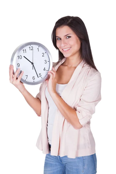 Beautiful woman holding a clock Royalty Free Stock Photos