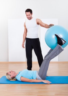 pilates egzersizleri ile bir kadın yardım eğitmeni