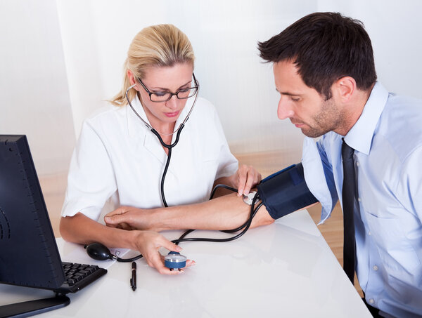 Doctor taking a patients blood pressure