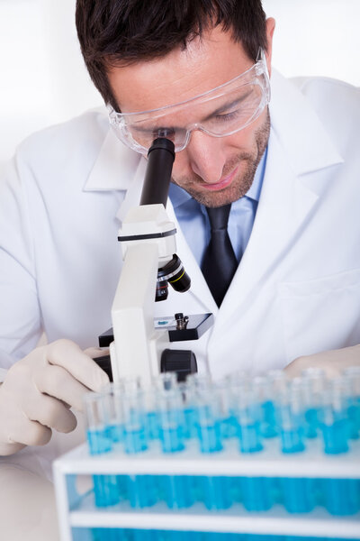 Pathologist or lab technician using a microscope