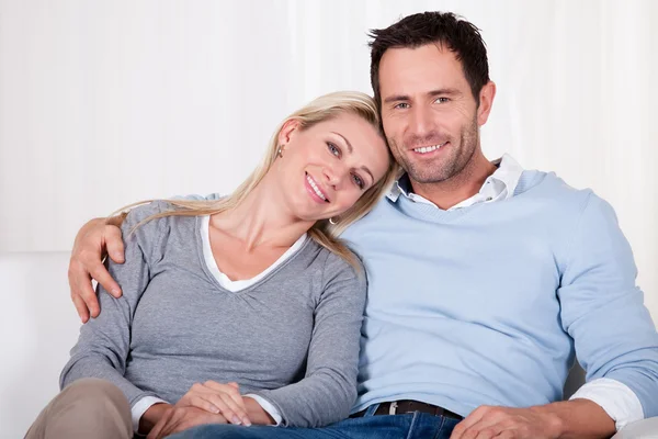 Affectionate couple relaxing on a sofa — Stock Photo, Image