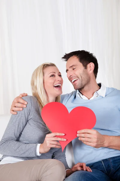 Romantic couple holding a red heart Royalty Free Stock Images