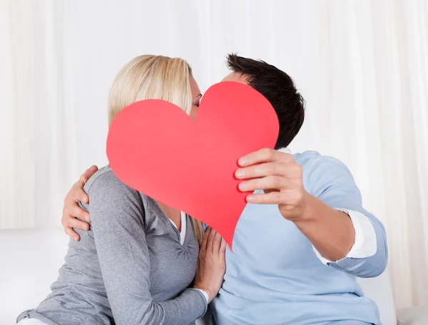 Romantic couple holding a red heart Stock Photo