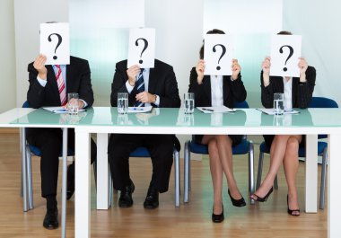 Row of businesspeople with question marks clipart