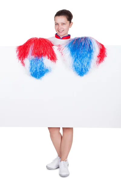 Giovane cheerleader con un segno in bianco — Foto Stock