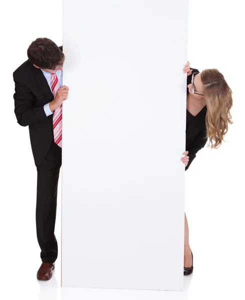 Professional man and woman with a blank sign — Stock Photo, Image