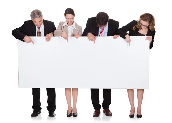 Businesspeople holding a blank banner — Stock Photo, Image