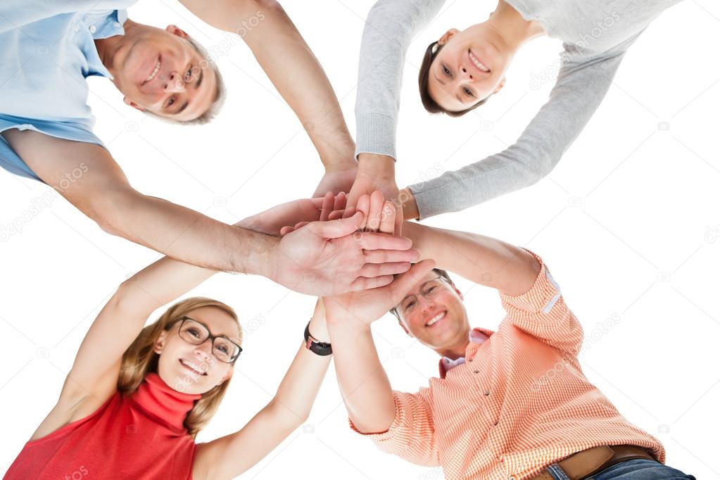 Four casual middle-aged friends holding hands