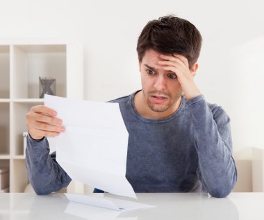 Horrified man reading a document