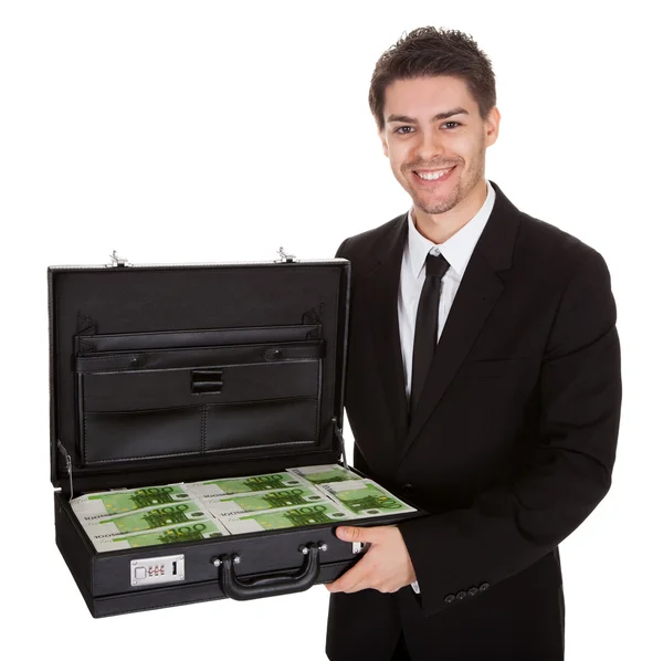 Businessman with suitcase full of cash — Stock Photo, Image