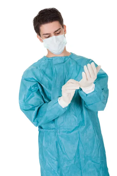 Surgeon putting on surgical gloves — Stock Photo, Image