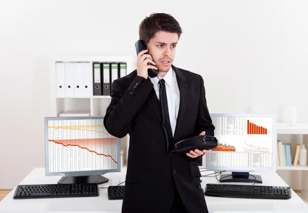 Worried stock broker on the phone — Stock Photo, Image