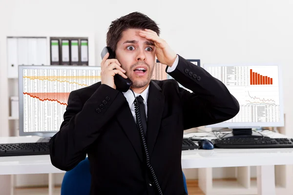 Worried stock broker on the phone — Stock Photo, Image