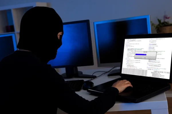 Hacker downloading information off a computer — Stock Photo, Image