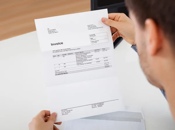 Man reading a invoice document — Stock Photo, Image