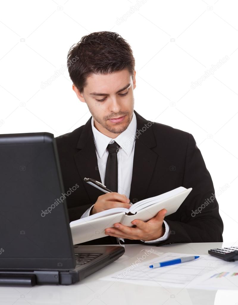 Businessman making a note in his diary