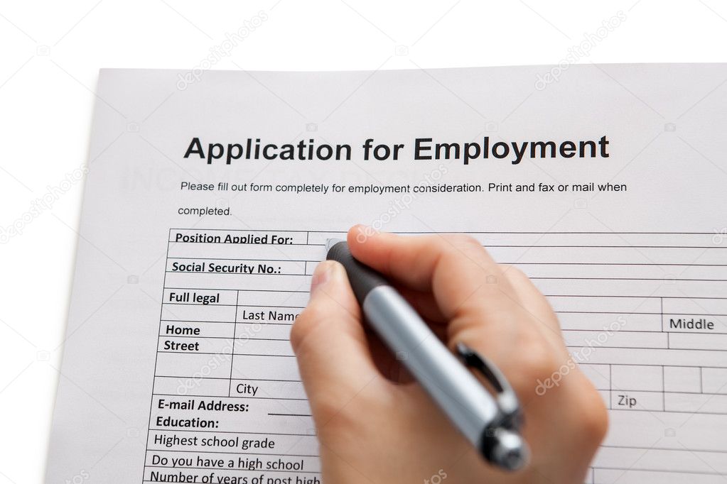 Male hand completing a job application