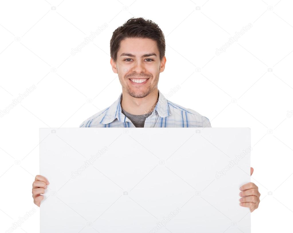 Smiling casual man with blank sign