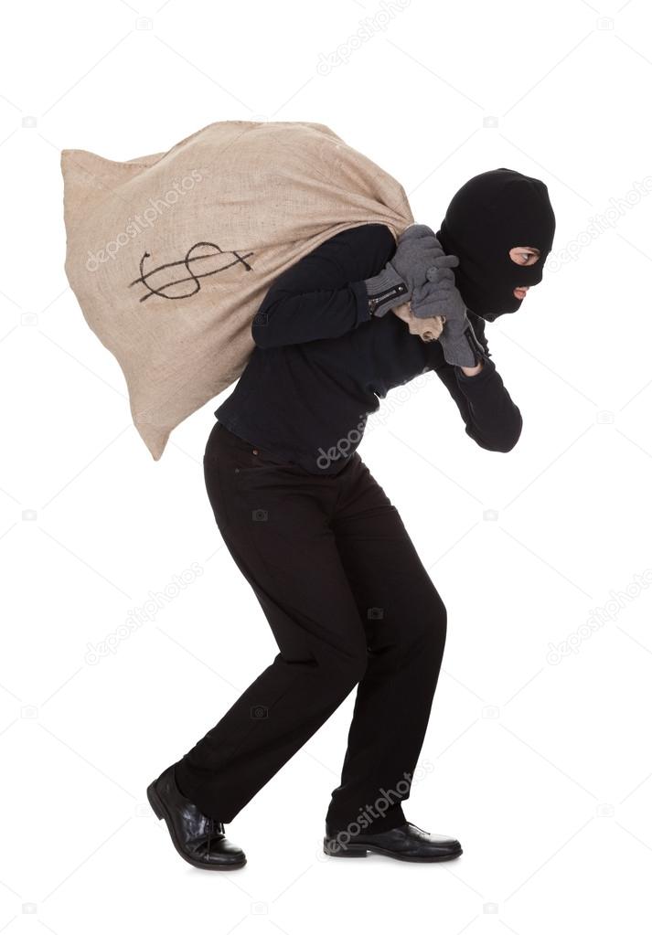 Thief carrying a large bag of money — Stock Photo © AndreyPopov 18926897