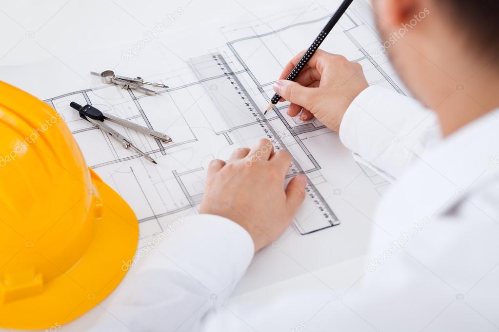 Architect working on blueprints