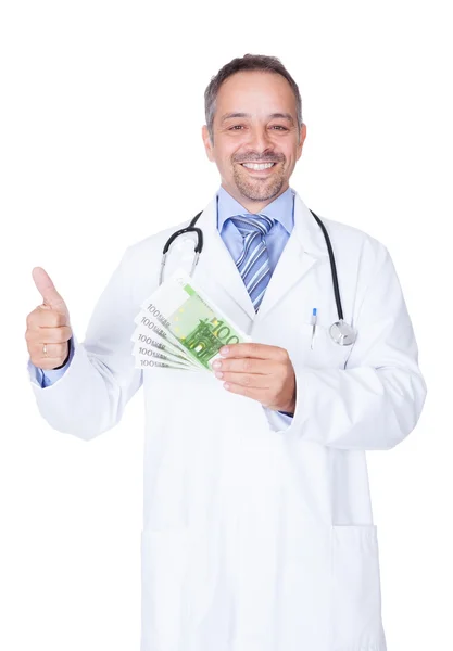 Feliz Doctor sosteniendo billetes en euros — Foto de Stock